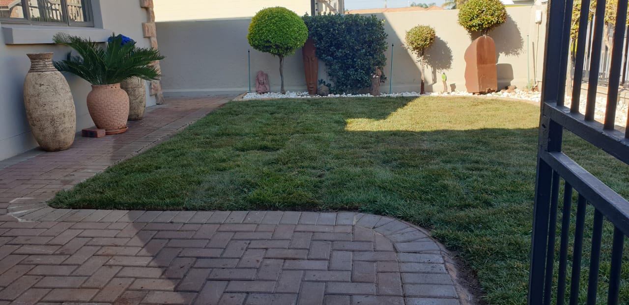 Professional artificial grass and paving installation by Green Chris Landscaping